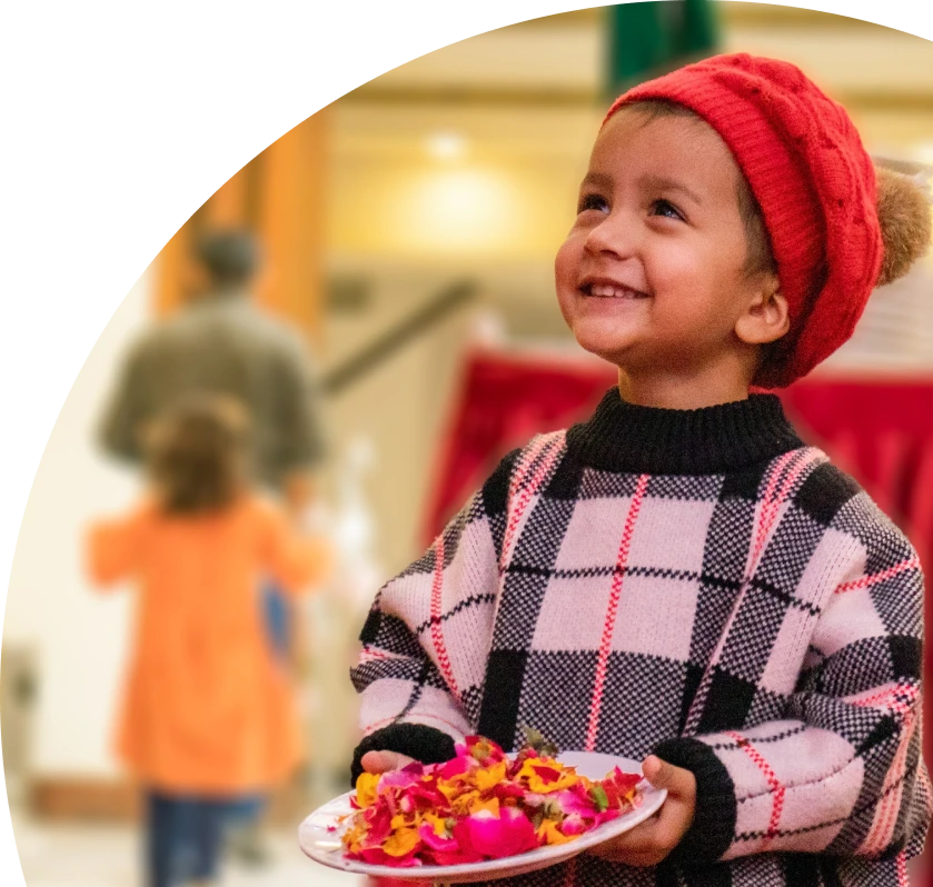 a happy child with a plate in his hand.